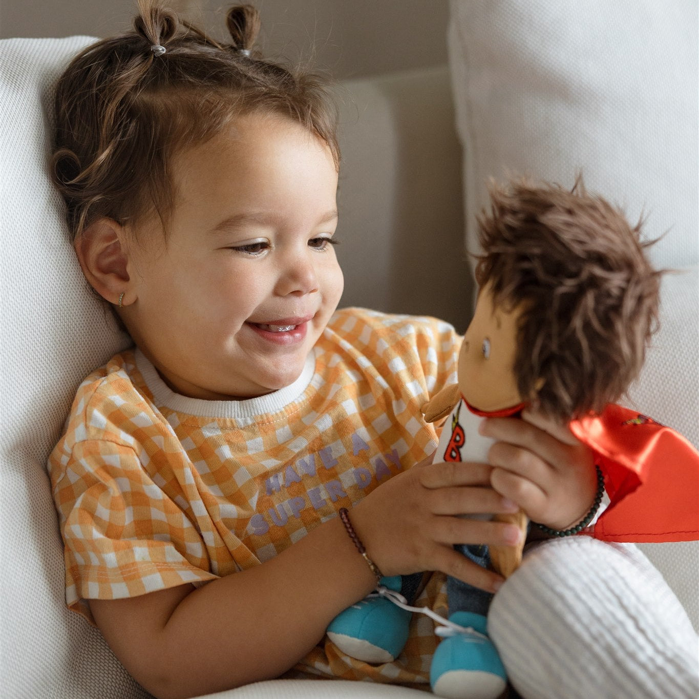 child playing with her team supercrew doll benny the brave
